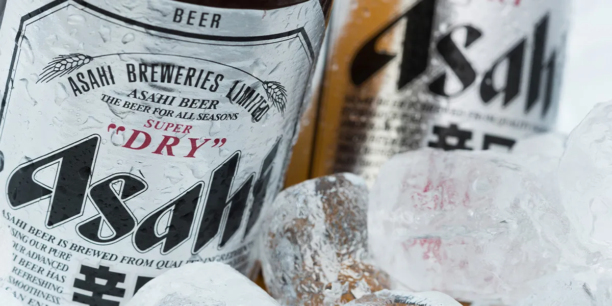 Close-up of chilled Asahi Super Dry beer bottles in ice, perfect for last bank holiday drinks 2025