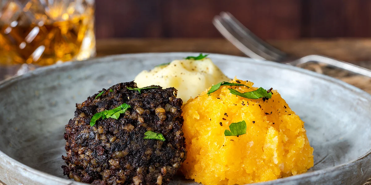 Traditional Burns Night haggis, neeps and tatties served with whisky, paired with January drinks deals near you